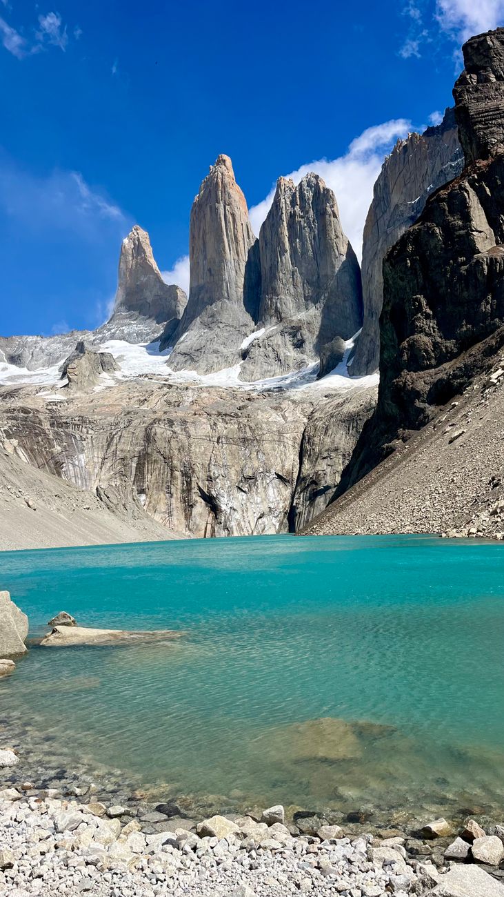 Panoramic view of Torres del Paine granite towers over glacial lake