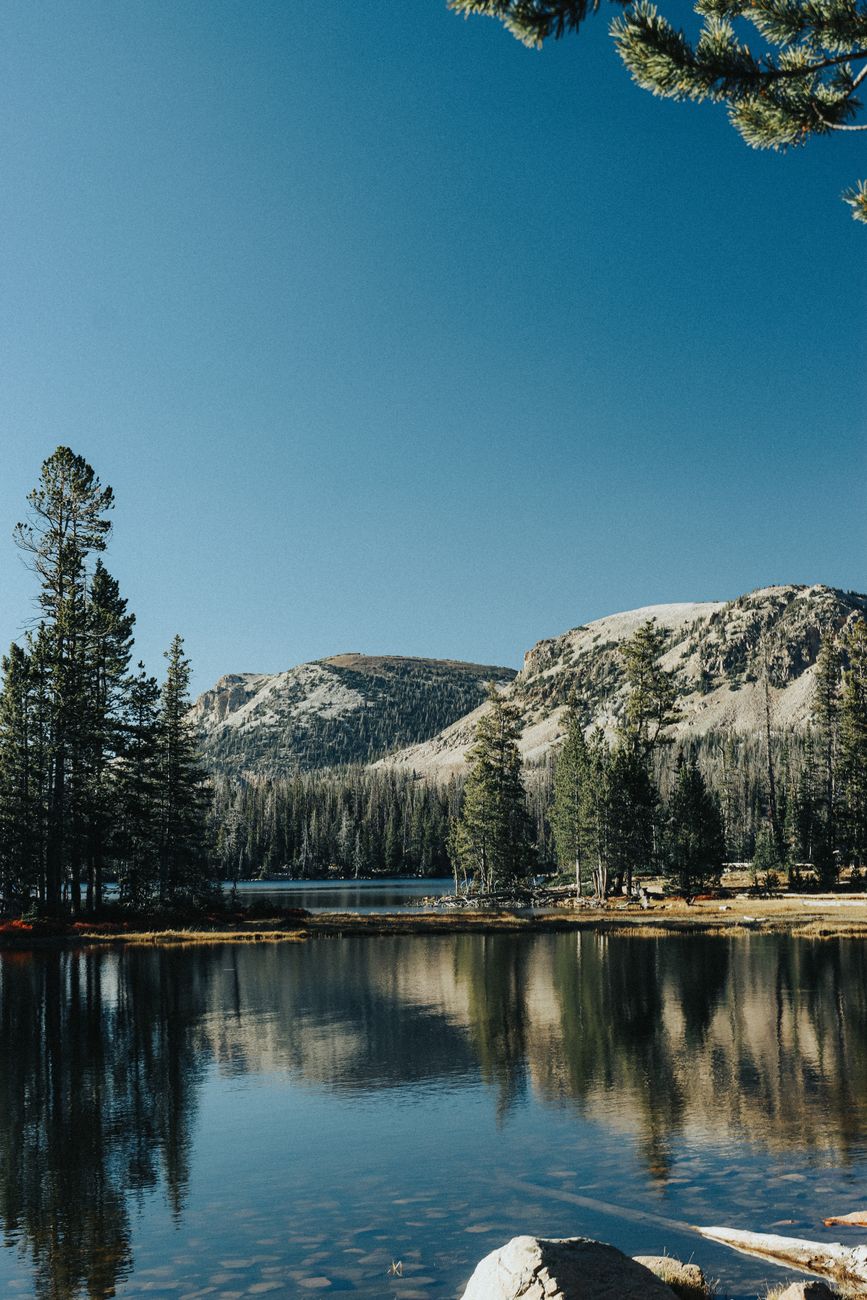 Quiet alpine lake in morning sunlight